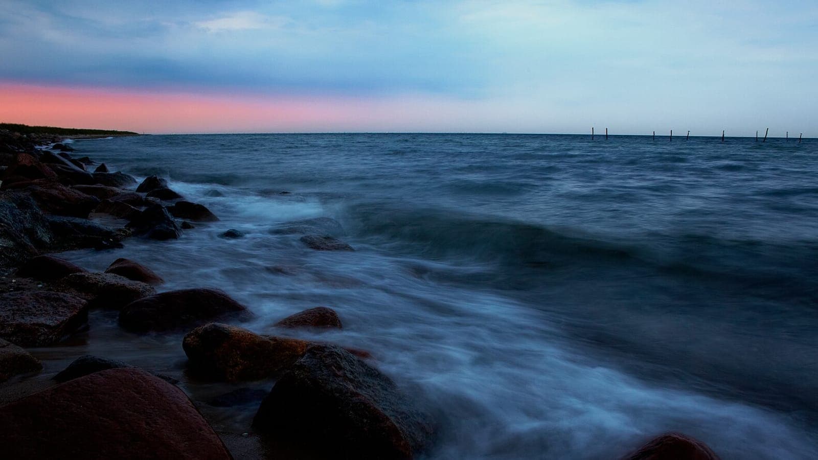 The rough Baltic Sea at dusk on the rocky shore at Kramnitse, Lolland