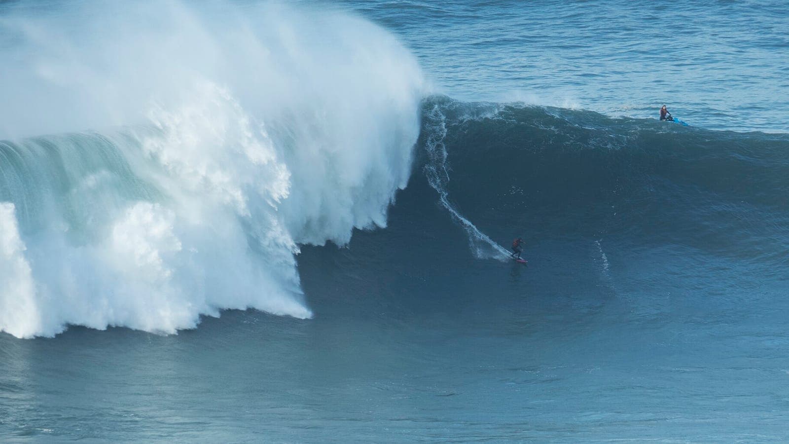 A surfer on a giant wave at Praia do Norte, Nazaré