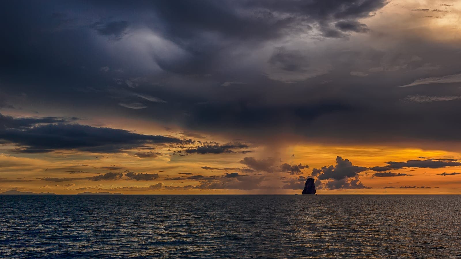 A rain squall over the Andaman Sea at sunset